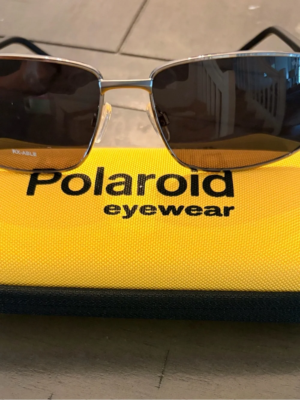 Polaroid Men’s Silver Frame Sunglasses with Black Lenses and Yellow Case